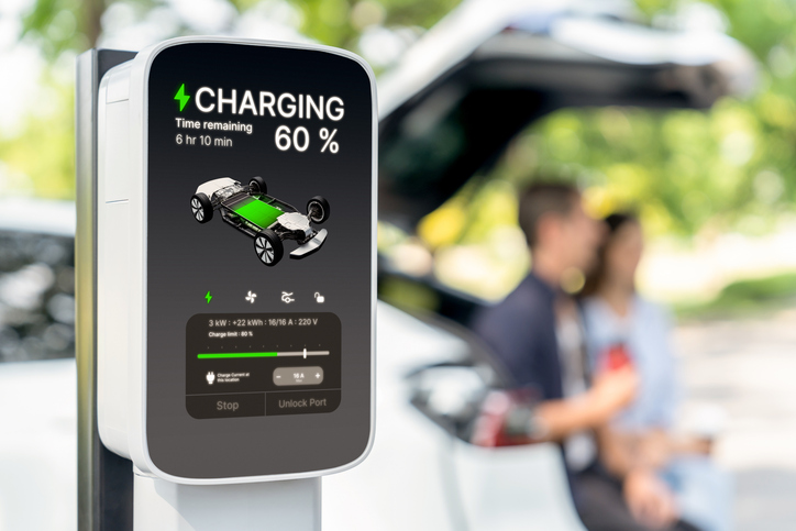 Focused EV charging station monitor display battery status for. Exalt